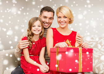 Image showing smiling family holding gift box