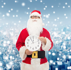 Image showing man in costume of santa claus with clock