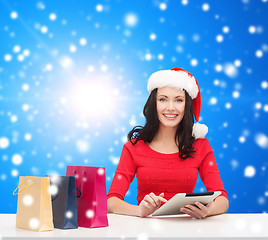 Image showing smiling woman with shopping bags and tablet pc