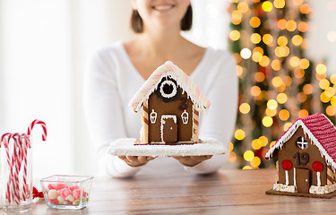 Image showing close up of woman showing gingerbread house