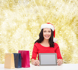 Image showing smiling woman with shopping bags and tablet pc