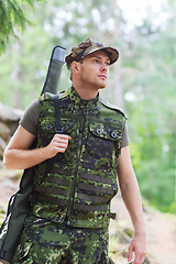 Image showing young soldier or hunter with gun in forest