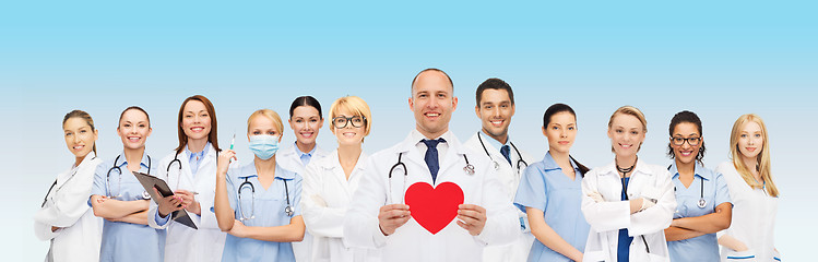 Image showing group of smiling doctors with red heart shape