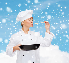 Image showing smiling female chef with pan and spoon