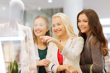 Image showing happy young women with shopping bags in mall