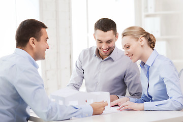 Image showing couple looking at model of their house at office