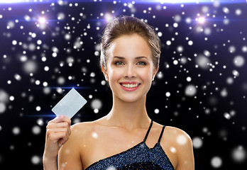 Image showing smiling woman in evening dress holding credit card