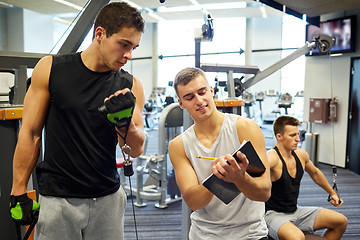 Image showing men exercising on gym machine