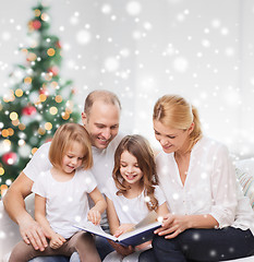 Image showing happy family with book at home