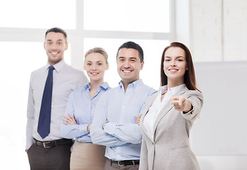 Image showing businesswoman in office pointing finger at you