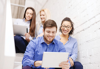 Image showing team with tablet pc computer sitting on staircase