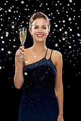 Image showing smiling woman holding glass of sparkling wine