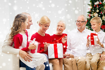 Image showing smiling family with gifts at home