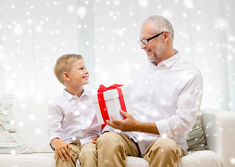 Image showing smiling grandfather and grandson at home