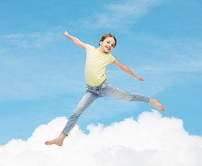 Image showing smiling little girl jumping