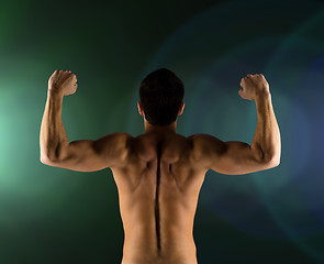 Image showing young man showing biceps and muscles