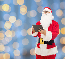 Image showing man in costume of santa claus with tablet pc