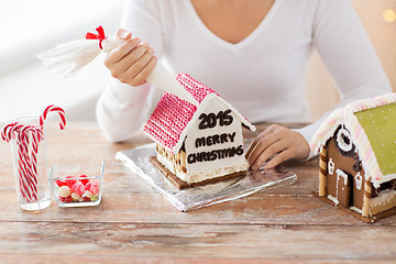 Image showing close up of woman making gingerbread houses