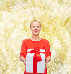 Image showing smiling woman in red clothes with gift box