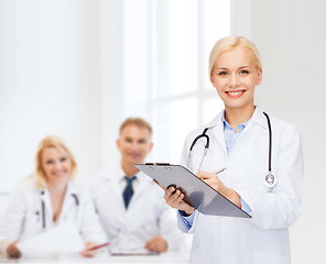 Image showing smiling female doctor with clipboard