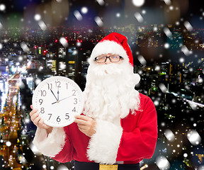 Image showing man in costume of santa claus with clock