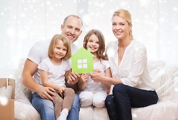 Image showing smiling parents and two little girls at new home