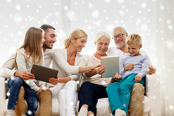 Image showing smiling family with tablet pc at home