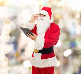 Image showing man in costume of santa claus with tablet pc