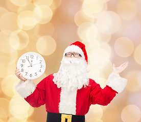 Image showing man in costume of santa claus with clock