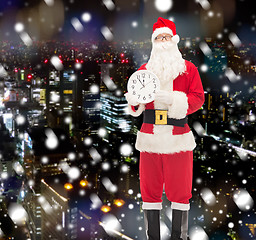 Image showing man in costume of santa claus with clock