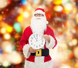 Image showing man in costume of santa claus with clock