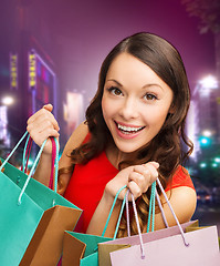 Image showing smiling young woman with shopping bags