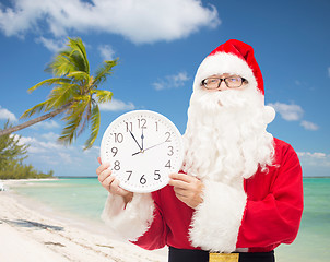 Image showing man in costume of santa claus with clock