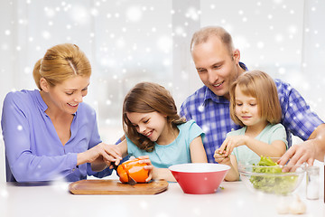 Image showing happy family with two kids making dinner at home