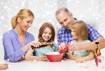 Image showing happy family with two kids making salad at home