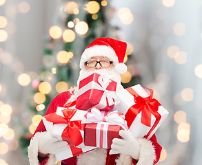 Image showing man in costume of santa claus with gift boxes