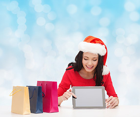 Image showing smiling woman with shopping bags and tablet pc