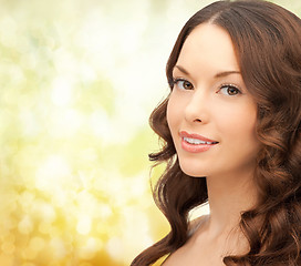 Image showing beautiful young woman over yellow background