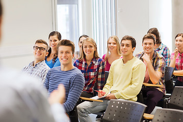 Image showing group of students and teacher with notebook