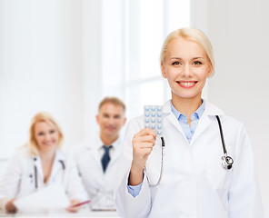 Image showing smiling female doctor with pills