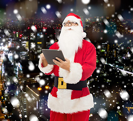 Image showing man in costume of santa claus with tablet pc