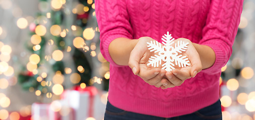 Image showing close up of woman holding snowflake decoration