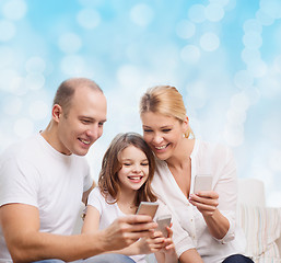 Image showing happy family with smartphones