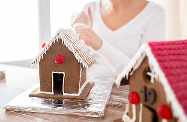 Image showing close up of woman making gingerbread houses