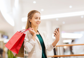 Image showing woman with smartphone shopping and taking selfie