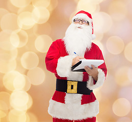 Image showing man in costume of santa claus with notepad