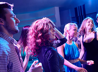 Image showing smiling friends dancing in club