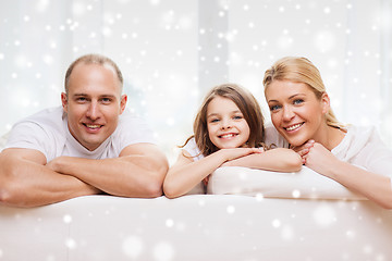 Image showing smiling parents and little girl at home