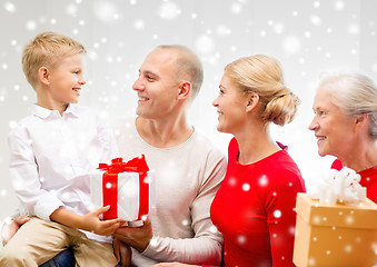 Image showing smiling family with gifts at home