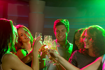 Image showing smiling friends with glasses of champagne in club